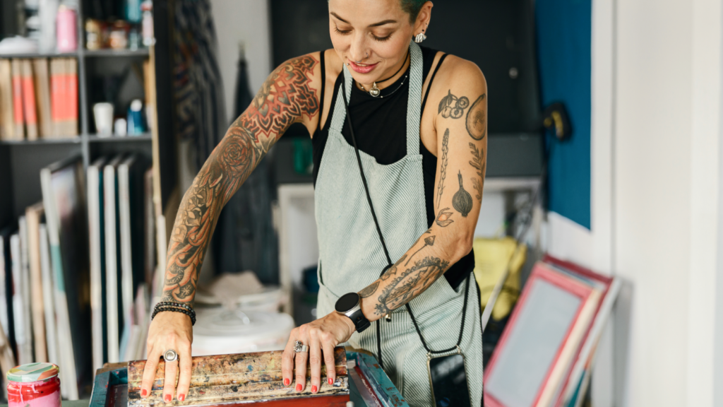 A woman is printing a print.