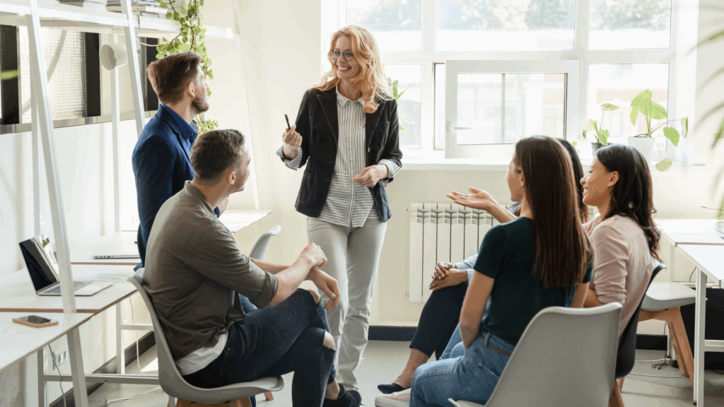 A woman teaching class for a group of students.