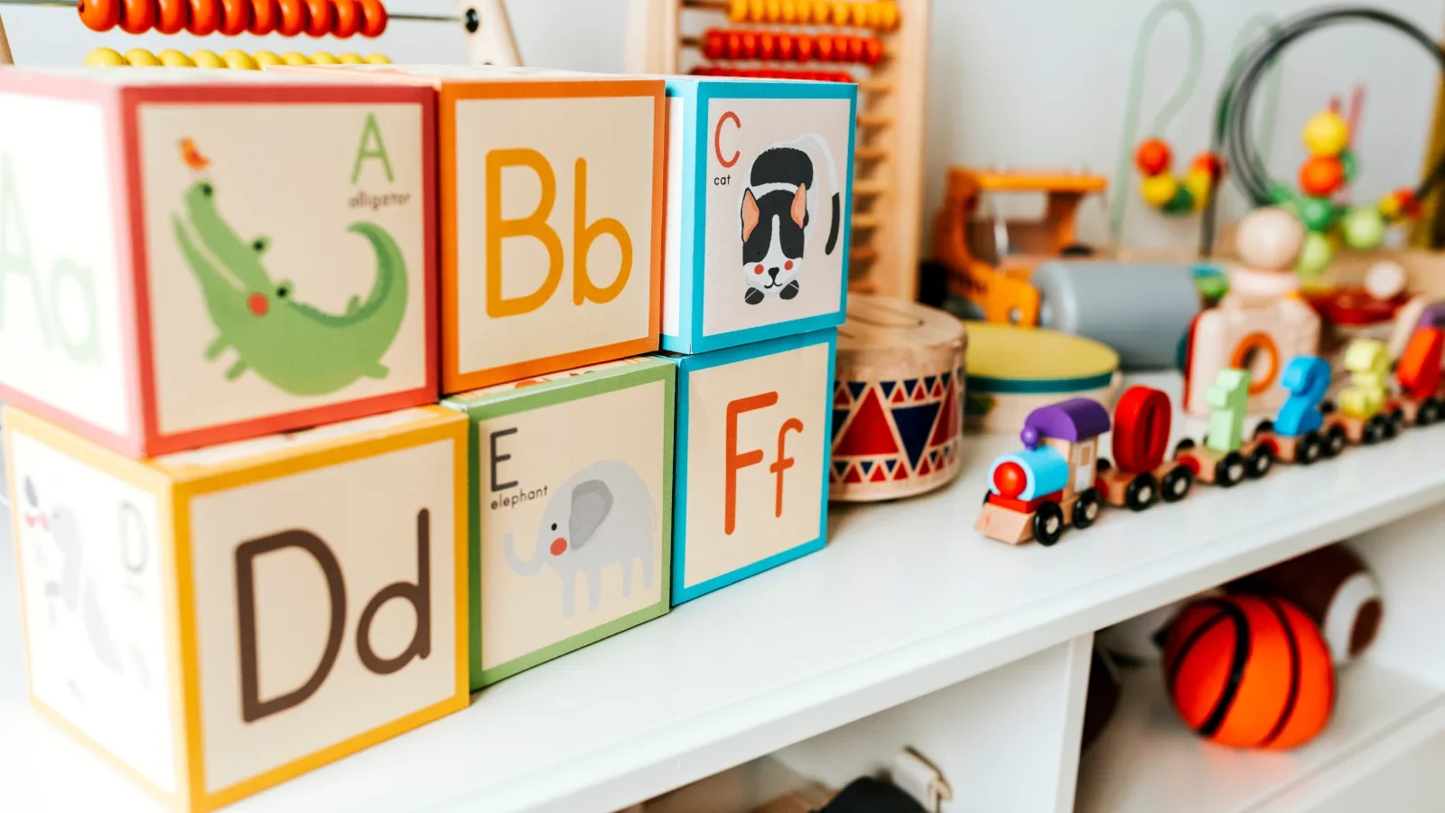 A shelf of different kids' toys.