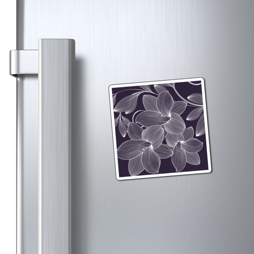 A square fridge magnet with floral artwork.