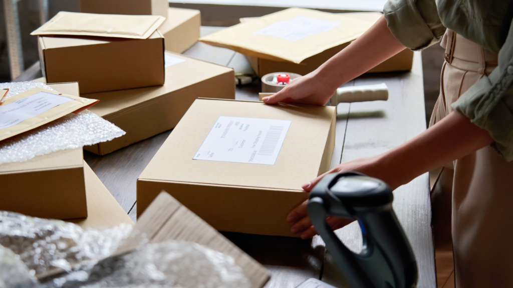 A person is opening a box to reveal a package inside, showcasing the anticipation of unboxing.