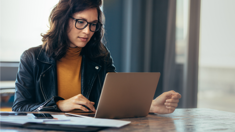 A woman is working on her laptop
