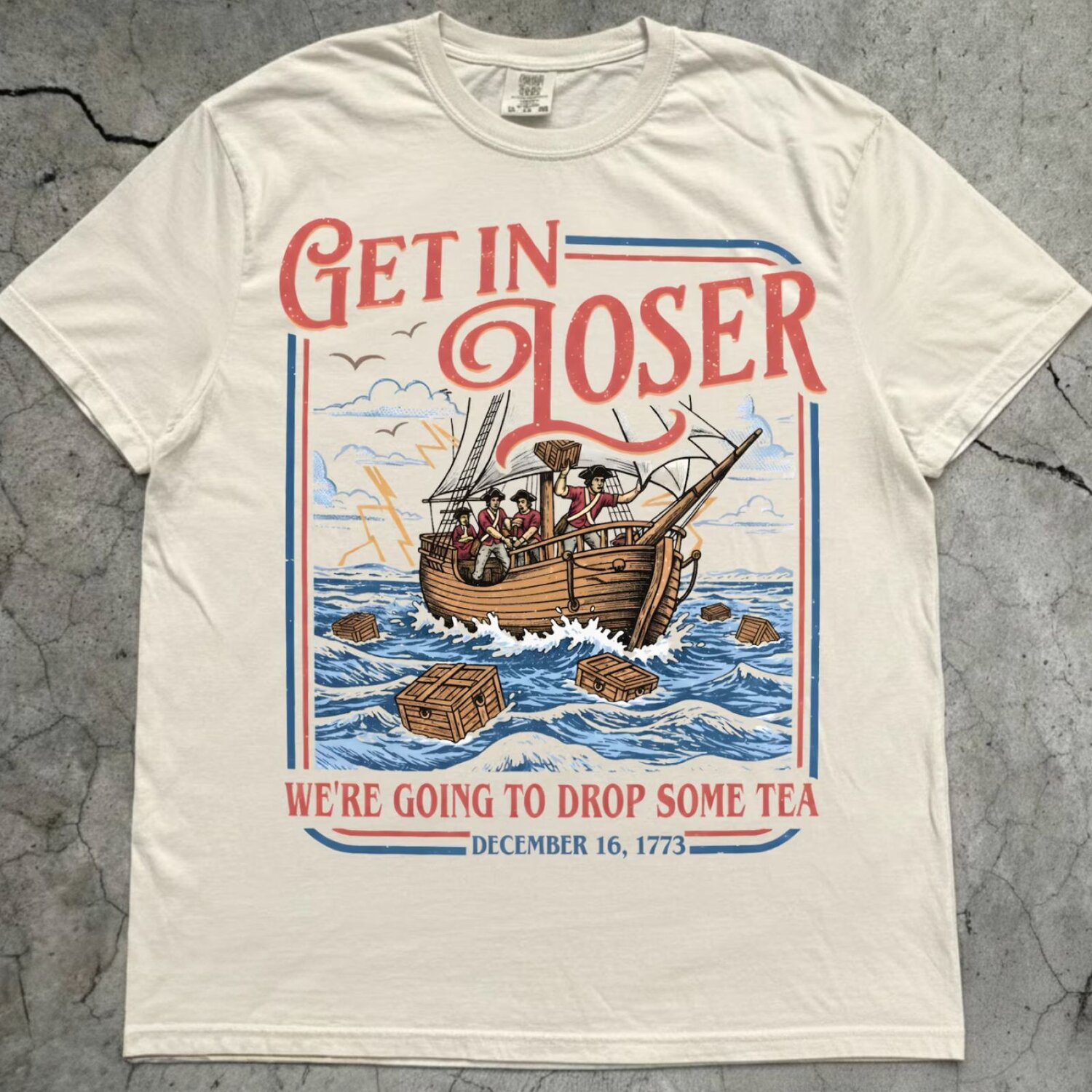 A woman posing in a beige 4th of July t-shirt that says 