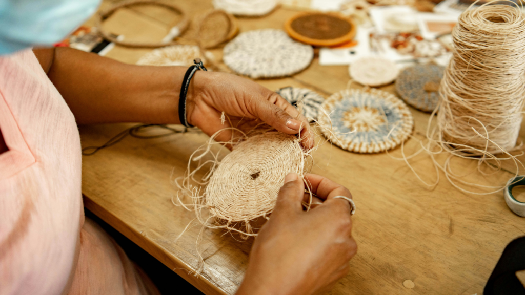 A person crafting handmade goods to sell and make money on Shopify.