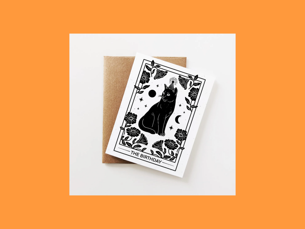 A greeting card with a black cat illustration on it.