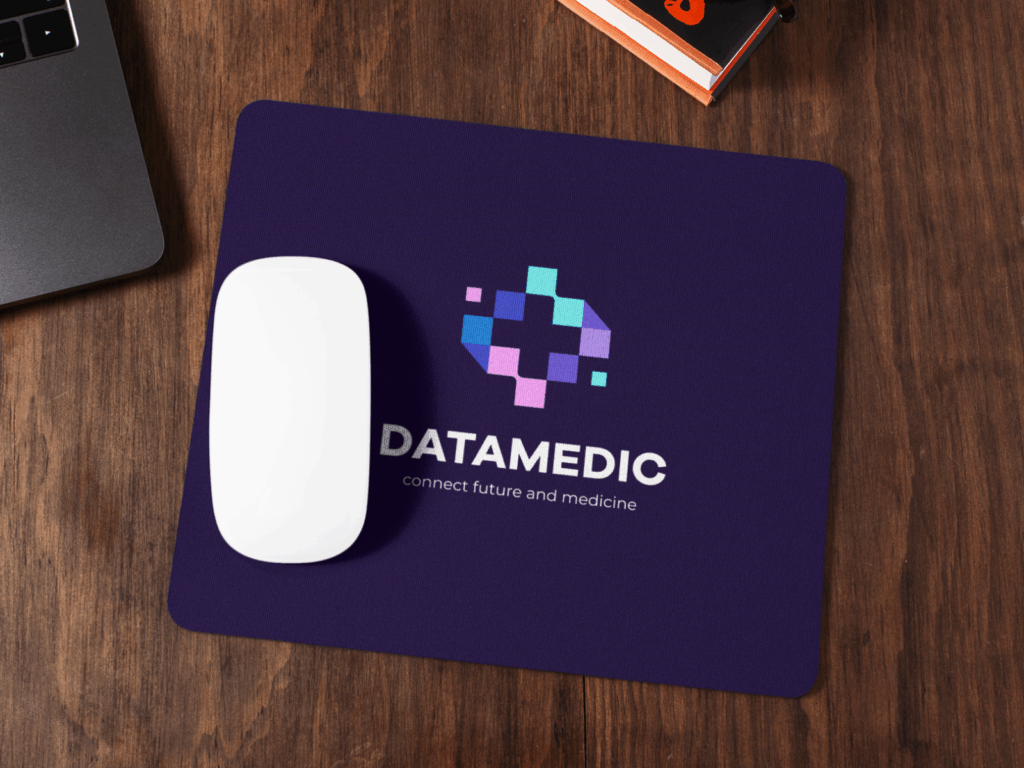 A purple “Datamedic” mousepad on a wooden table.
