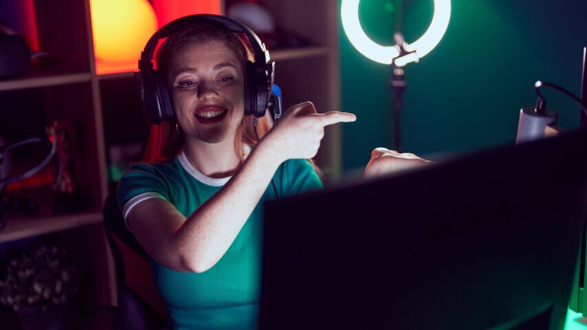 A woman with headphones recording a live Twitch stream.