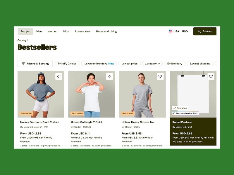 The Printify catalog Bestsellers page showing blank T-shirts from Comfort Colors and Gildan and rolled posters, with prices, sizes, colors, and print provider counts.
