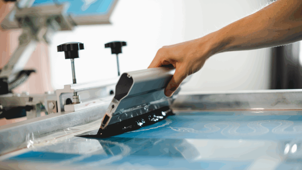 A person engaged in printing on paper with a specialized machine.