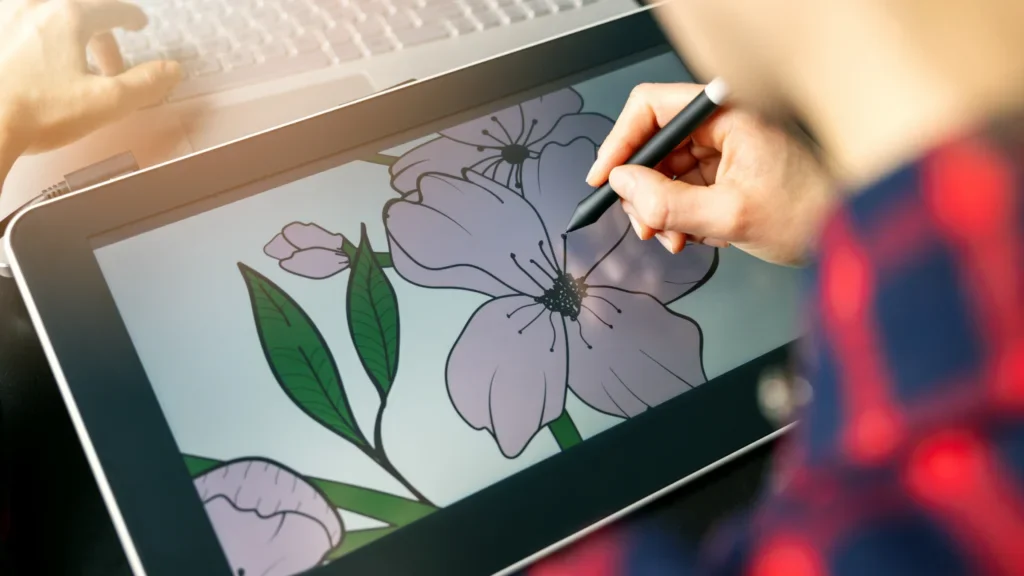 A person sketches vibrant flowers on a tablet, showcasing creativity and artistry in a digital format.