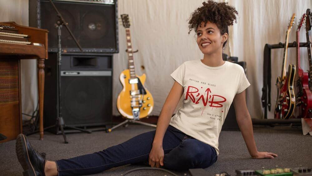 A woman wearing a custom white Gildan 5000L t-shirt with an “R'n'B” print.