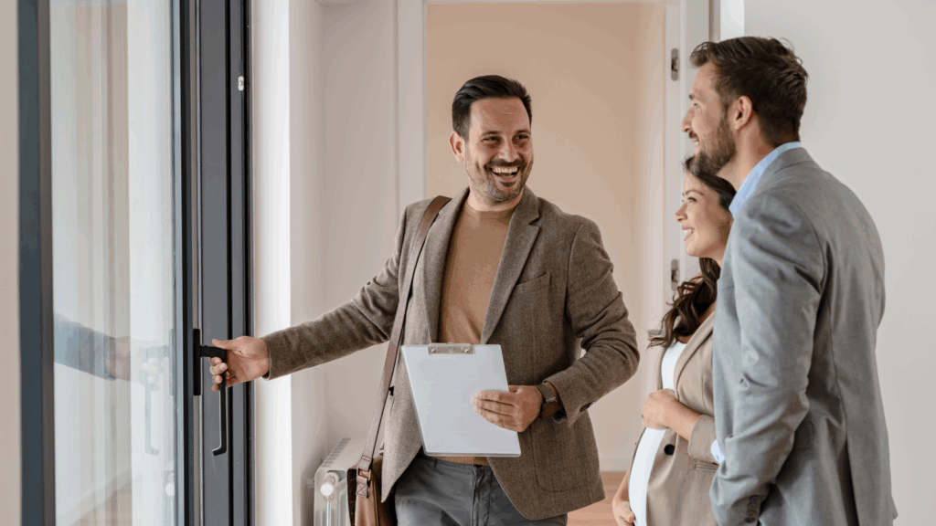 A man showing an apartment for a couple.