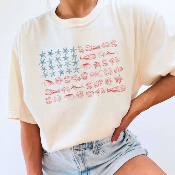 A couple wearing white 4th of July-themed t-shirts.