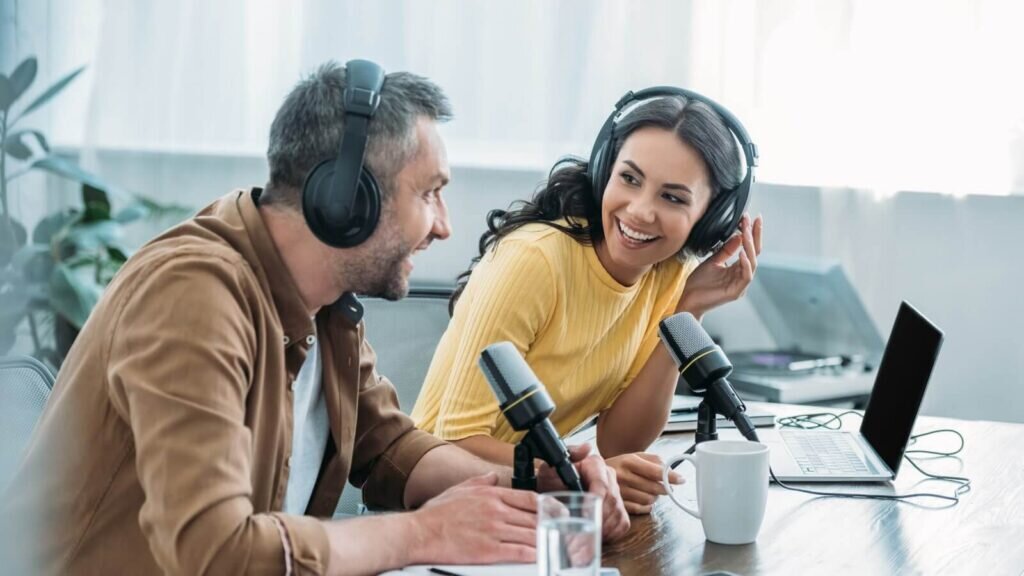 A man and a woman recording a podcast.