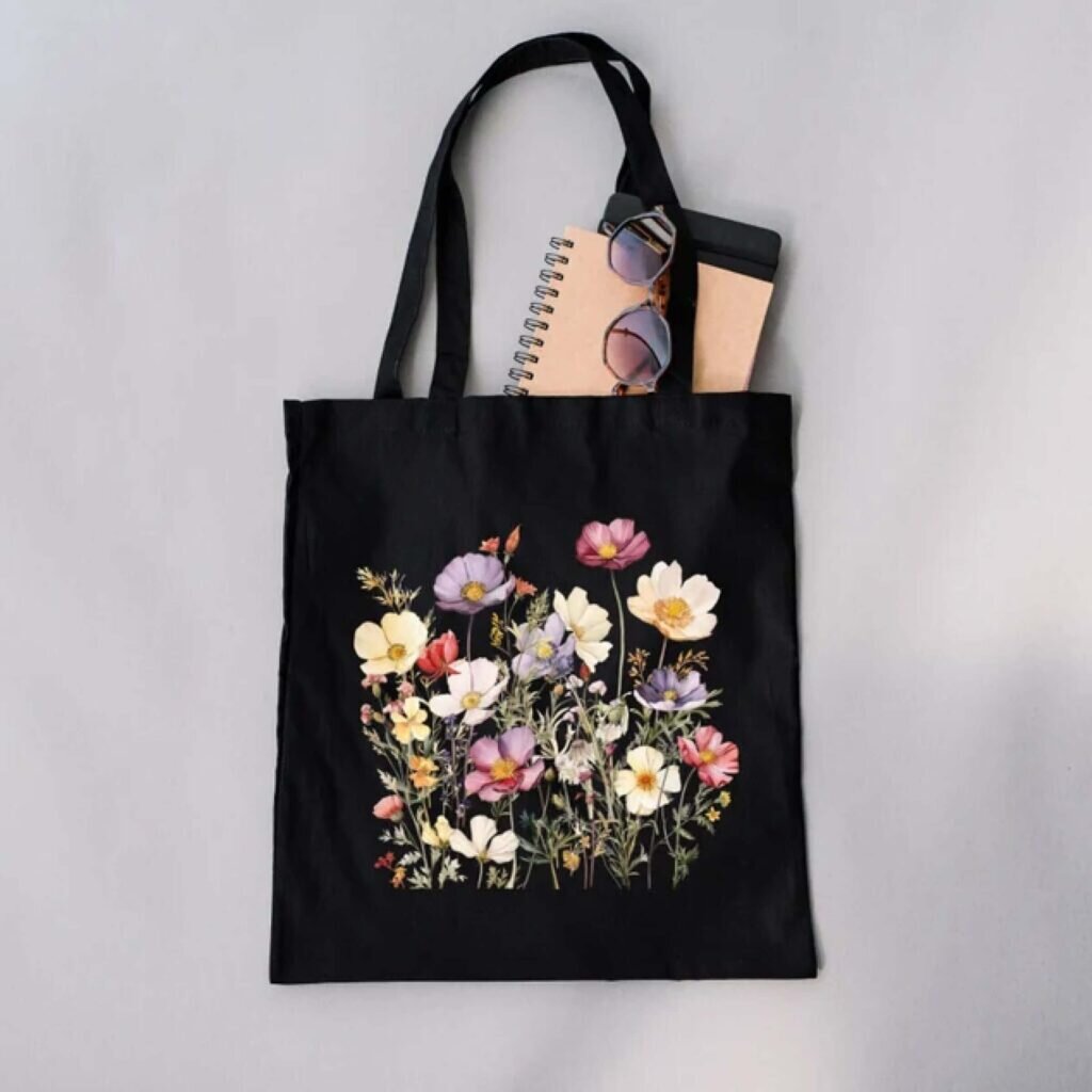 A black tote bag with a floral design.