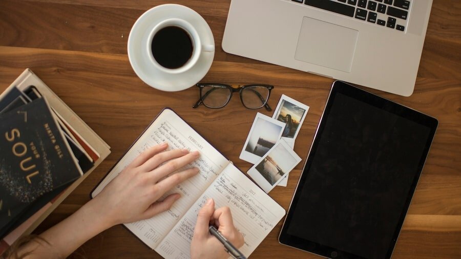 Person writing in a notebook.