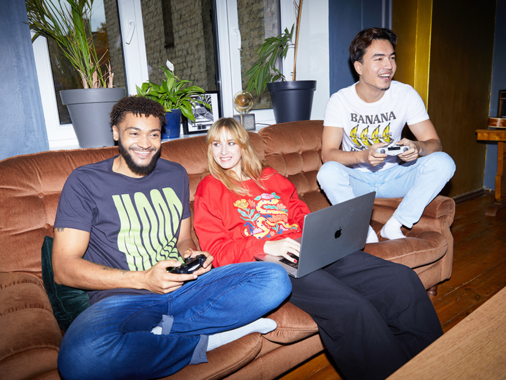 A group of people (two men and one woman), wearing custom clothing made with print-on-demand.