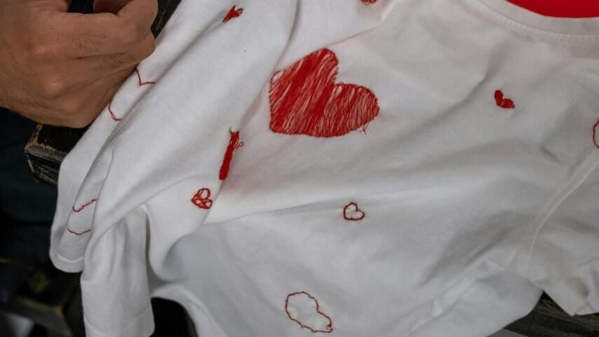 A custom white t-shirt with embroidered hearts.