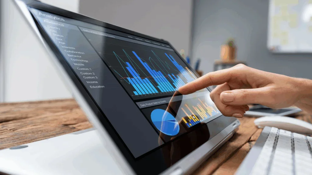A person pointing at a graph on a screen and analyzing information.