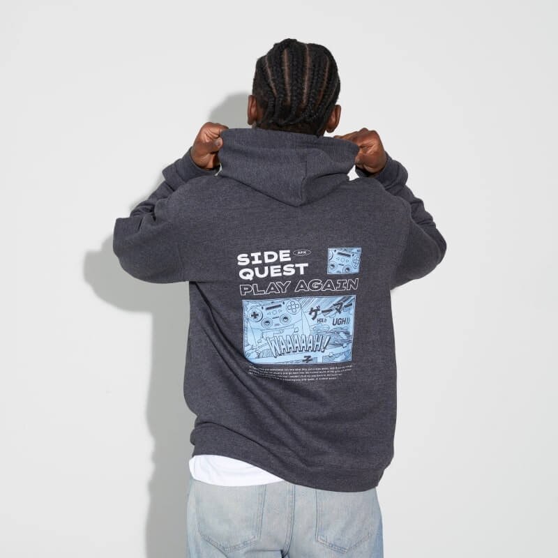 A person wearing a gray hoodie with a colorful back print.