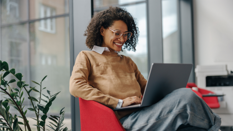 A woman is working on a laptop