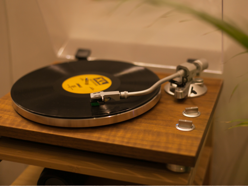 A vintage record player rests on a wooden table, adding a touch of nostalgia to the cozy setting.