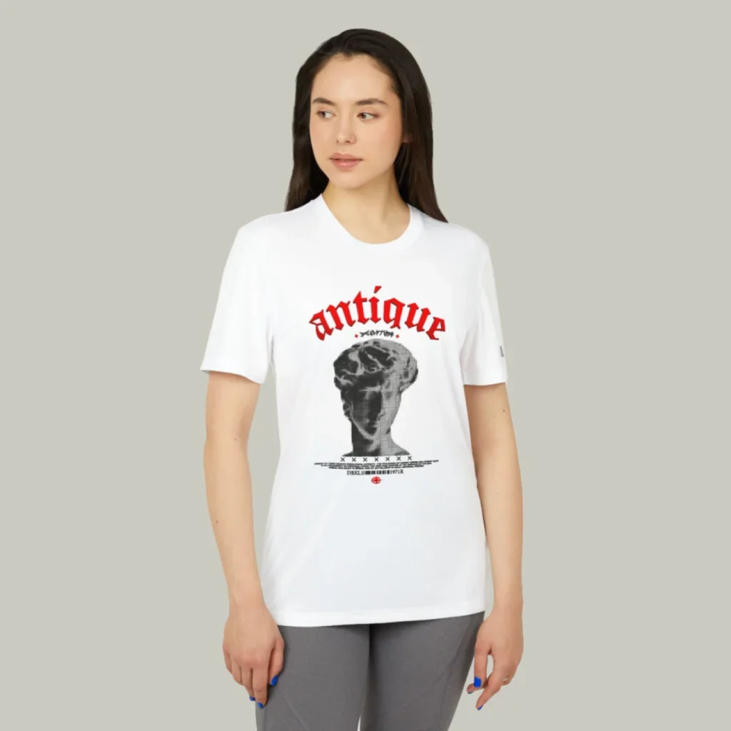 A mockup of a woman wearing a t-shirt with a custom “Antique” print on a light-green background.