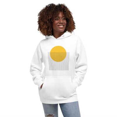 A woman wearing a white hoodie with an abstract design with geometric shapes.