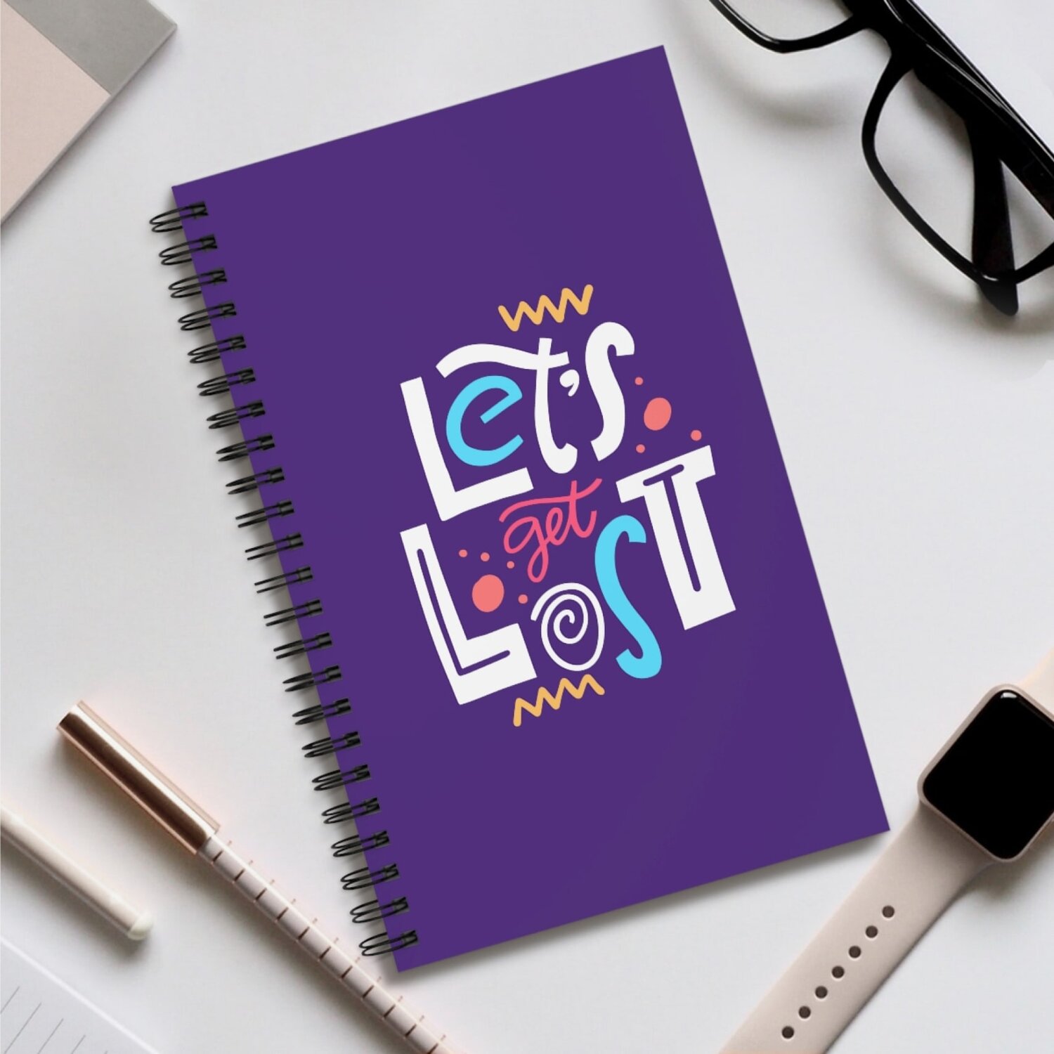 Custom notebook in purple with an abstract “Let's Get Lost” text print.