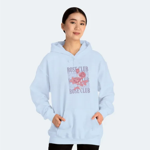A woman in a light blue “Rose Club” hoodie against a white background.