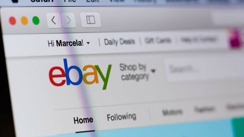 eBay website on the laptop screen.