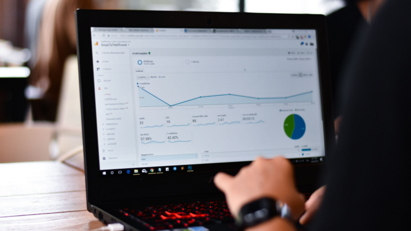 A person focused on a laptop displaying a graph, indicating data analysis or presentation.