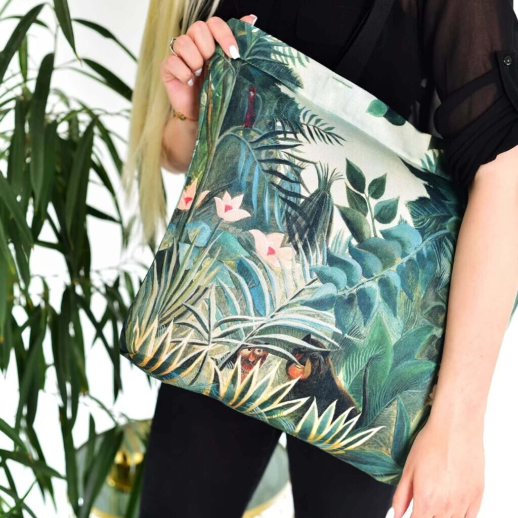 An AOP tote bag with a green leafy design.