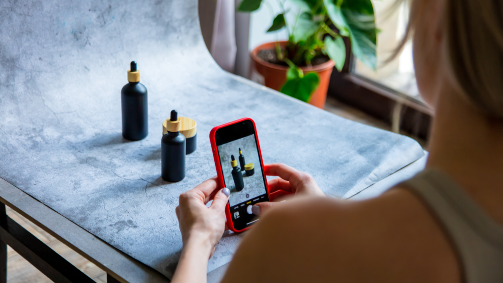 A woman taking a product picture with her mobile phone.