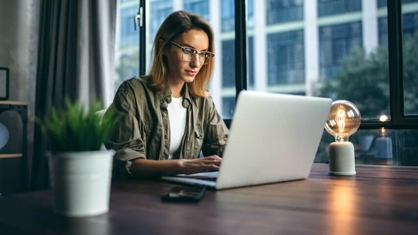 A woman typing on her laptop.