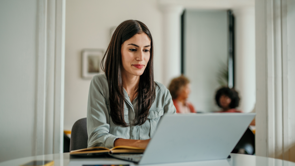 A woman sitting in front of a laptop.