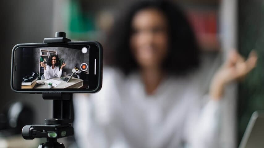 A woman filming a product review video.