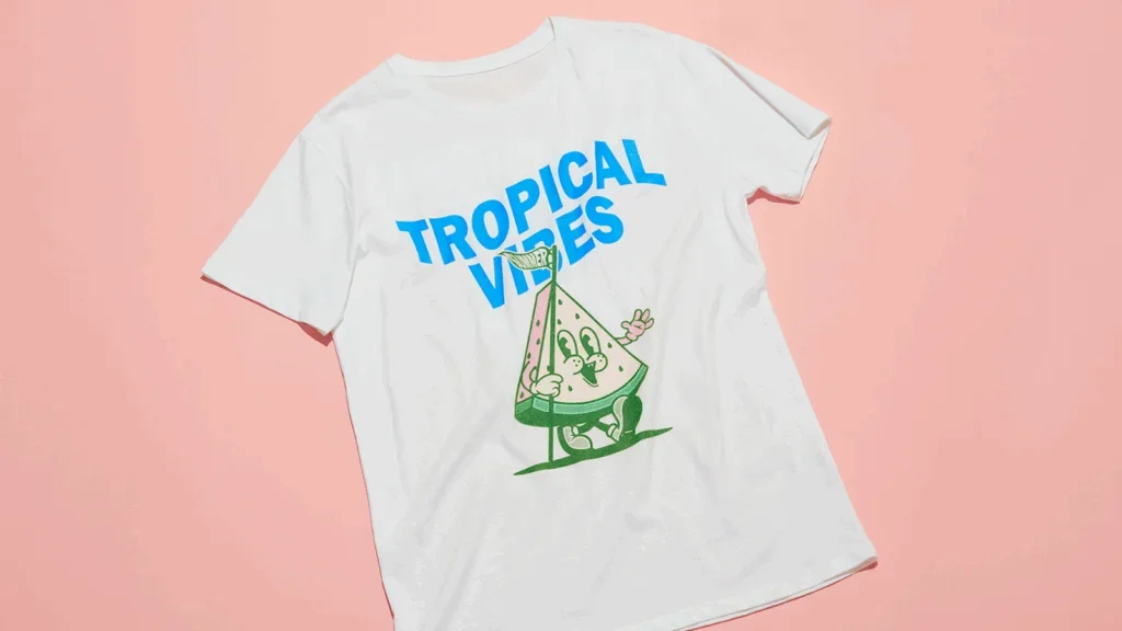 A t-shirt featuring the phrase "Tropical Vibes" in a vibrant, playful font.