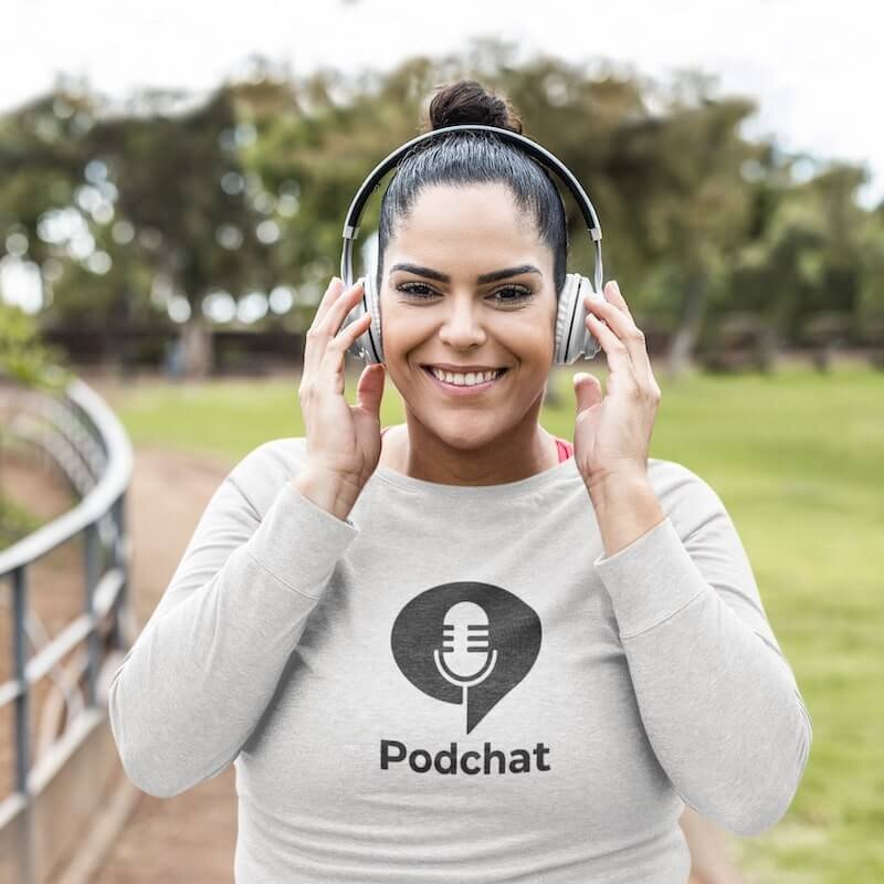A woman in headphones wearing a custom long-sleeve tee with a “Podchat” logo.