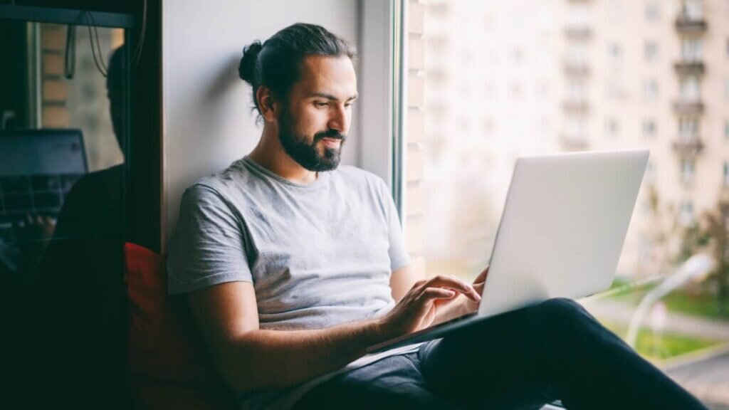 A man doing Amazon product research on his laptop.