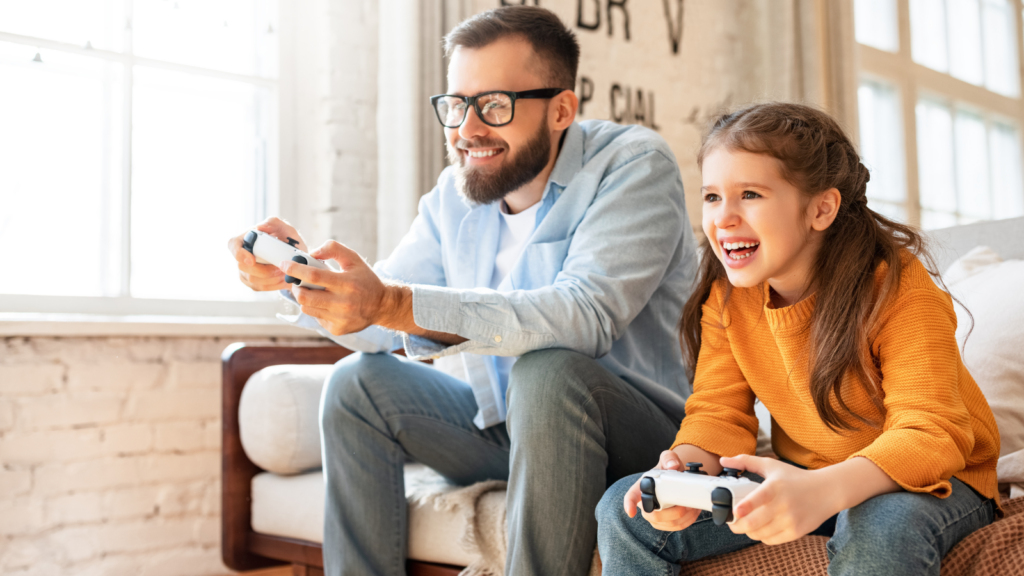 A man and a young girl joyfully playing video games together, sharing smiles and excitement in a cozy living room setting.