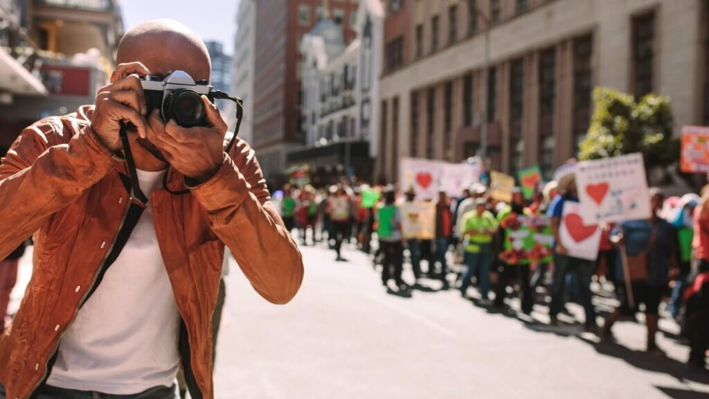A photographer taking photos at a peaceful march.