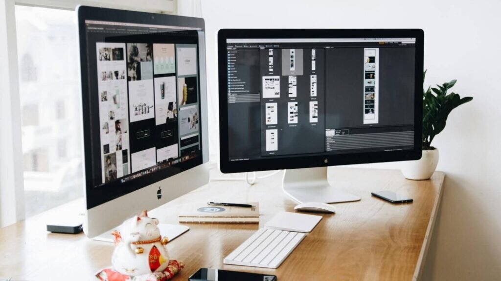 Two displays with website design in the process.