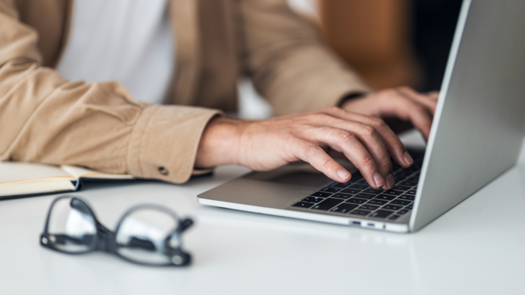 A person is typing on a laptop.