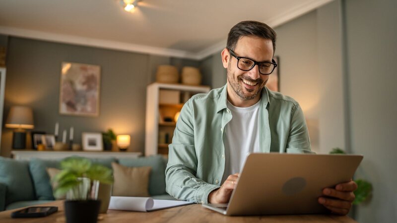 A man is working on a laptop
