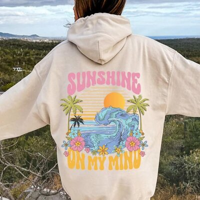 A palm tree, beach, and flower design on a hoodie that says "Sunshine on my mind."