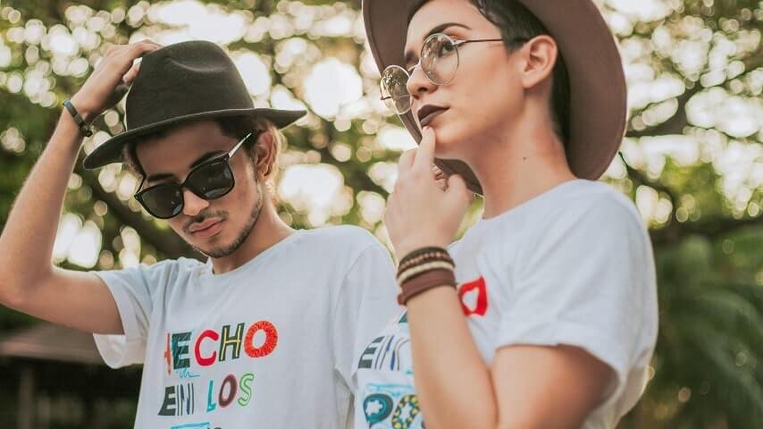 A man and a woman wearing custom t-shirts created with print on demand.