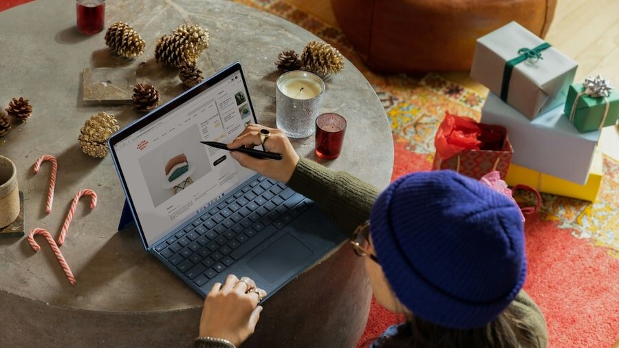 A person sitting and working on a laptop.