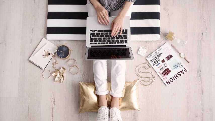 A woman creating blog content for her fashion business.