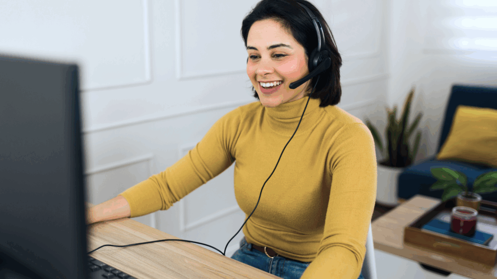 A smiling woman working as a virtual assistant.